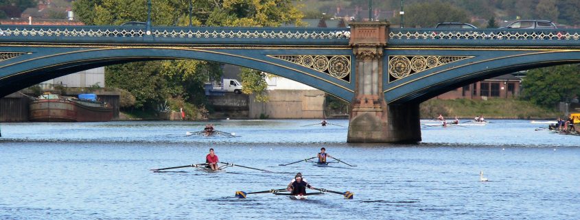 A photo of some crews rowing through Trent Bridge