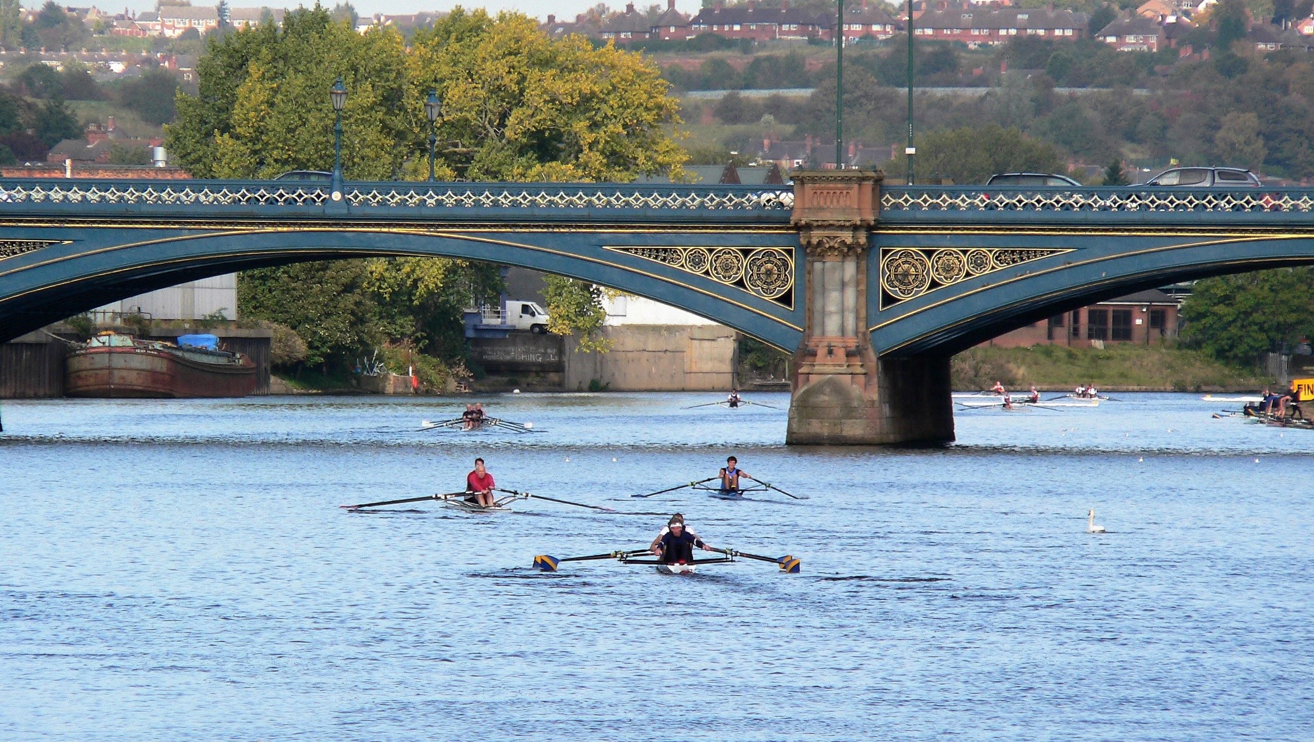 A photo of some crews rowing through Trent Bridge